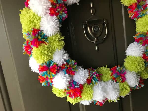 pom pom wreath close up on door